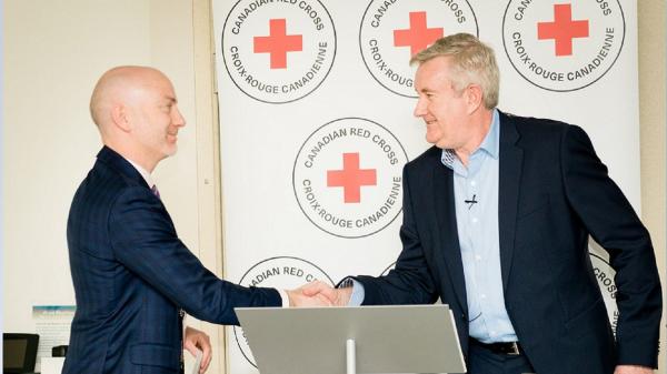 Stephen Thompson, President Baxter Canada, right, with Ronan Ryan, Chief Marketing and Development Officer, Canadian Red Cross launching Baxter’s Welcome Home corporate giving program with Baxter employees.